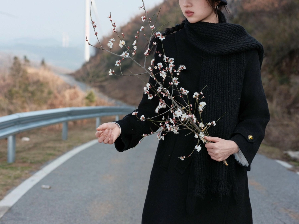 Rong Er posing against a stunning landscape