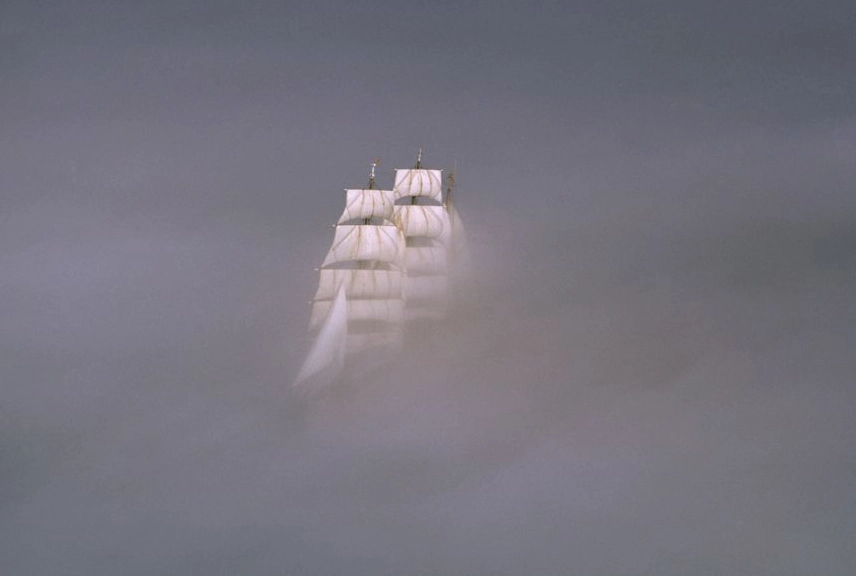 A large ship sailing through thick fog