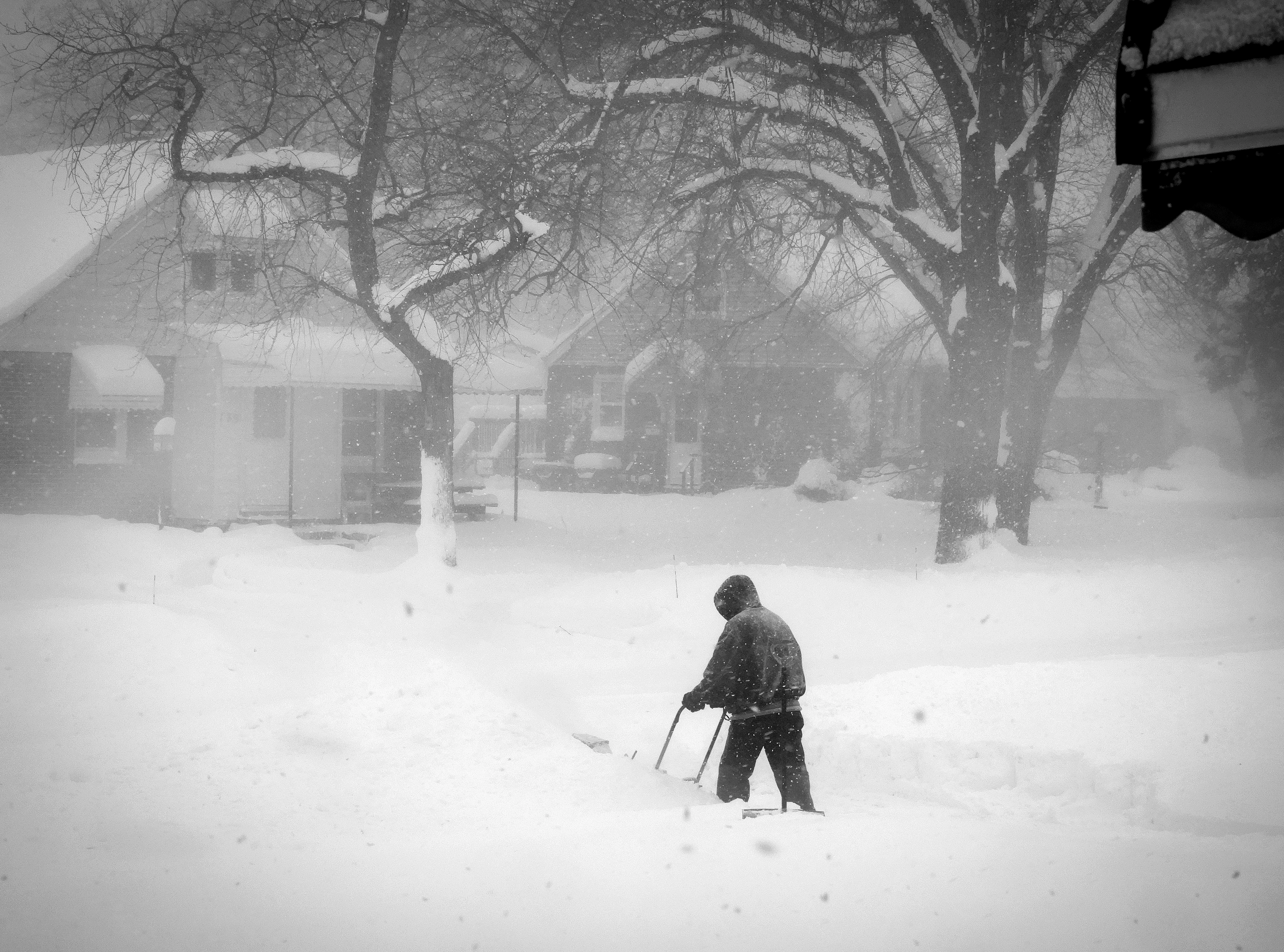A person clearing snow after a major blizzard in Buffalo, NY