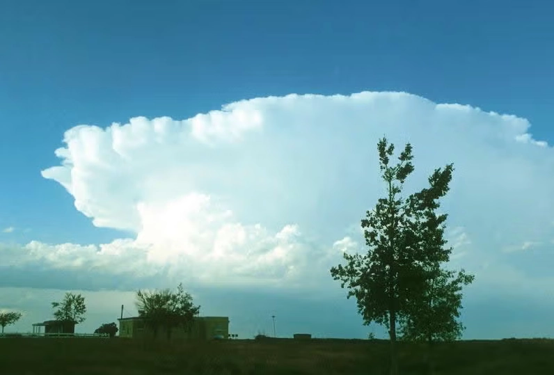 A towering cumulonimbus cloud with a distinct anvil shape