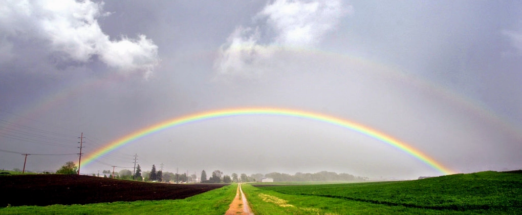 A vibrant double rainbow arching across a sky after a storm