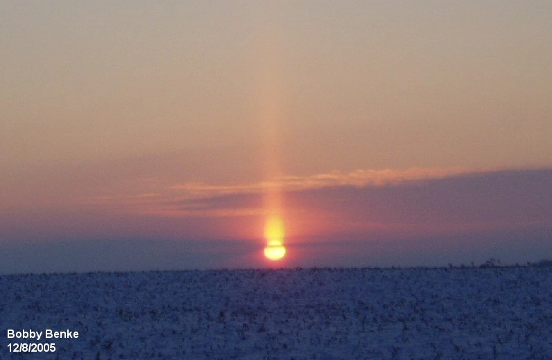 A wide-angle view showing a sun pillar during twilight.