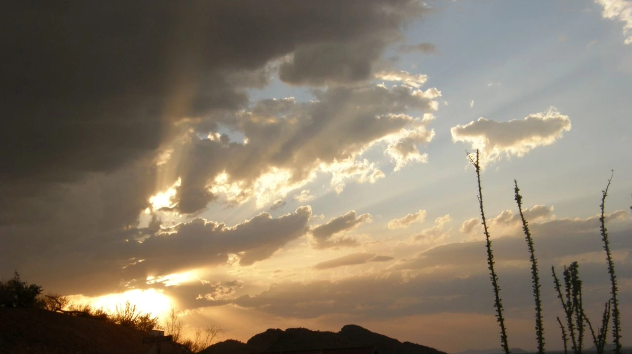 Dramatic crepuscular rays illuminating the sky near mountain peaks