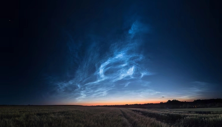 Noctilucent clouds glowing above the horizon after sunset