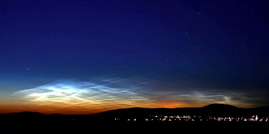 Noctilucent clouds glowing on the horizon