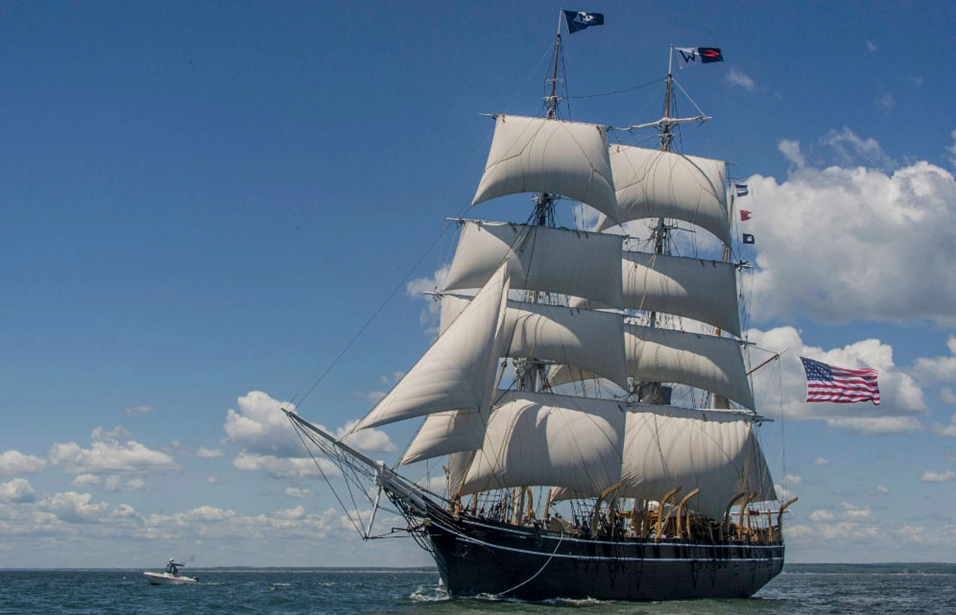 The Charles W. Morgan, a historic whaling ship, sailing on the ocean.